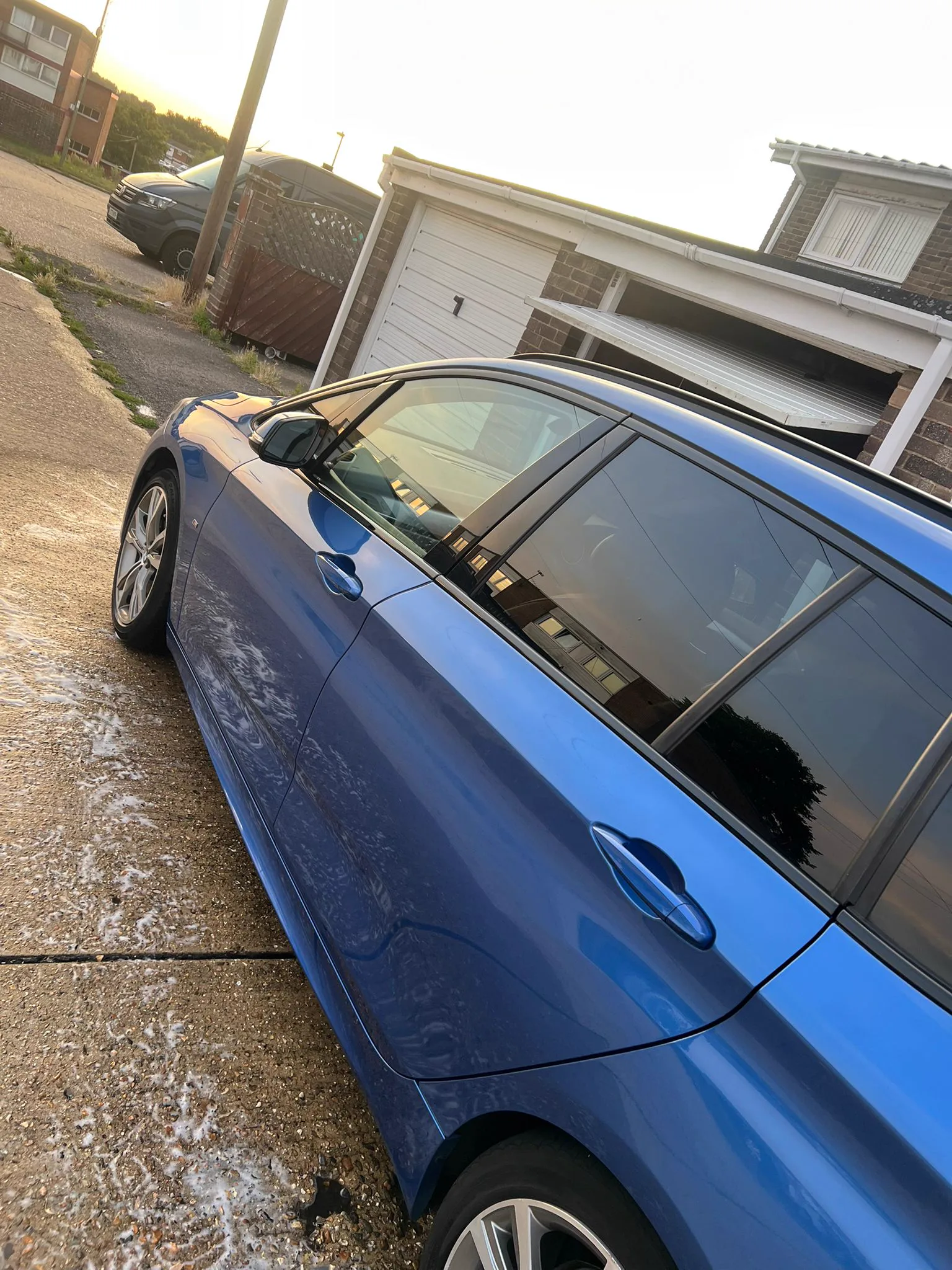 Side profile of a detailed blue BMW with spotless paint and trim, Havant detailing