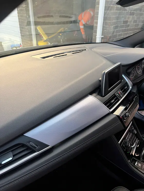 Clean BMW dashboard trim after an interior detail by PH Detailing