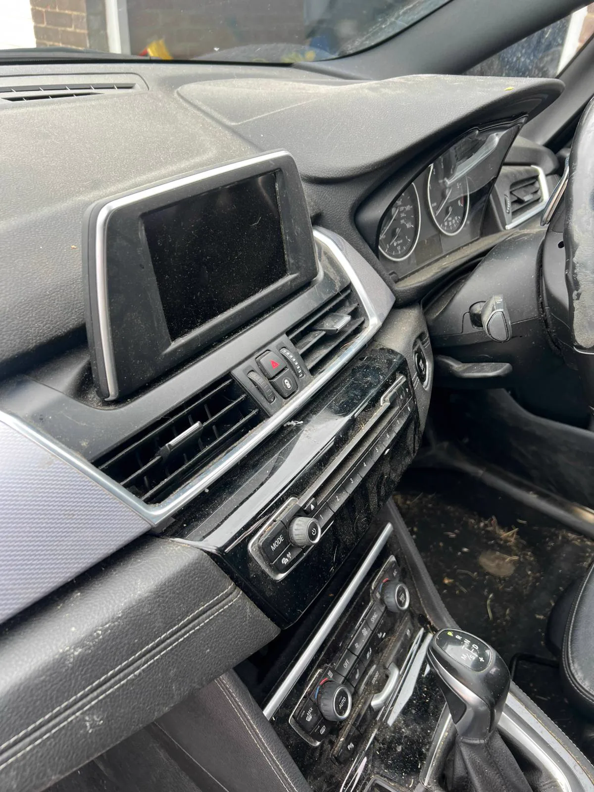 Dusty, grubby BMW dashboard and centre console before detailing in Hampshire
