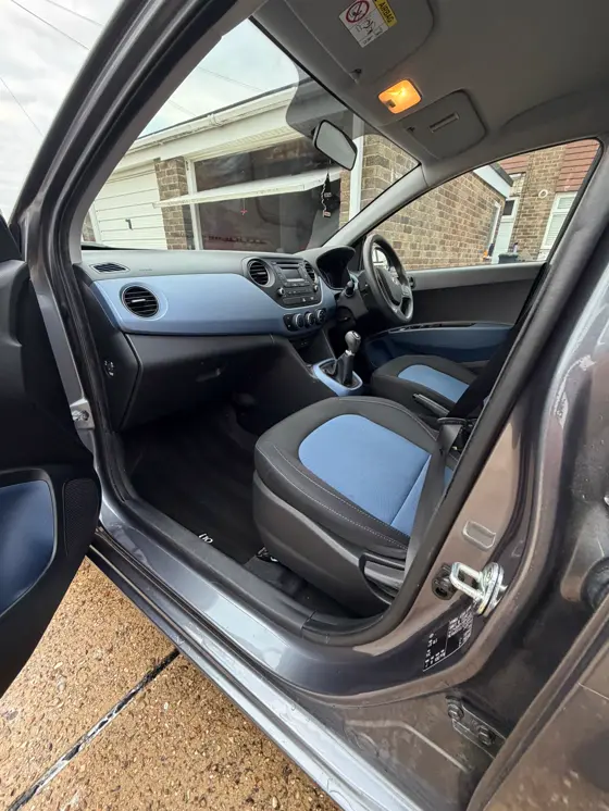 Hyundai i10 side view with clean blue and grey interior after detailing