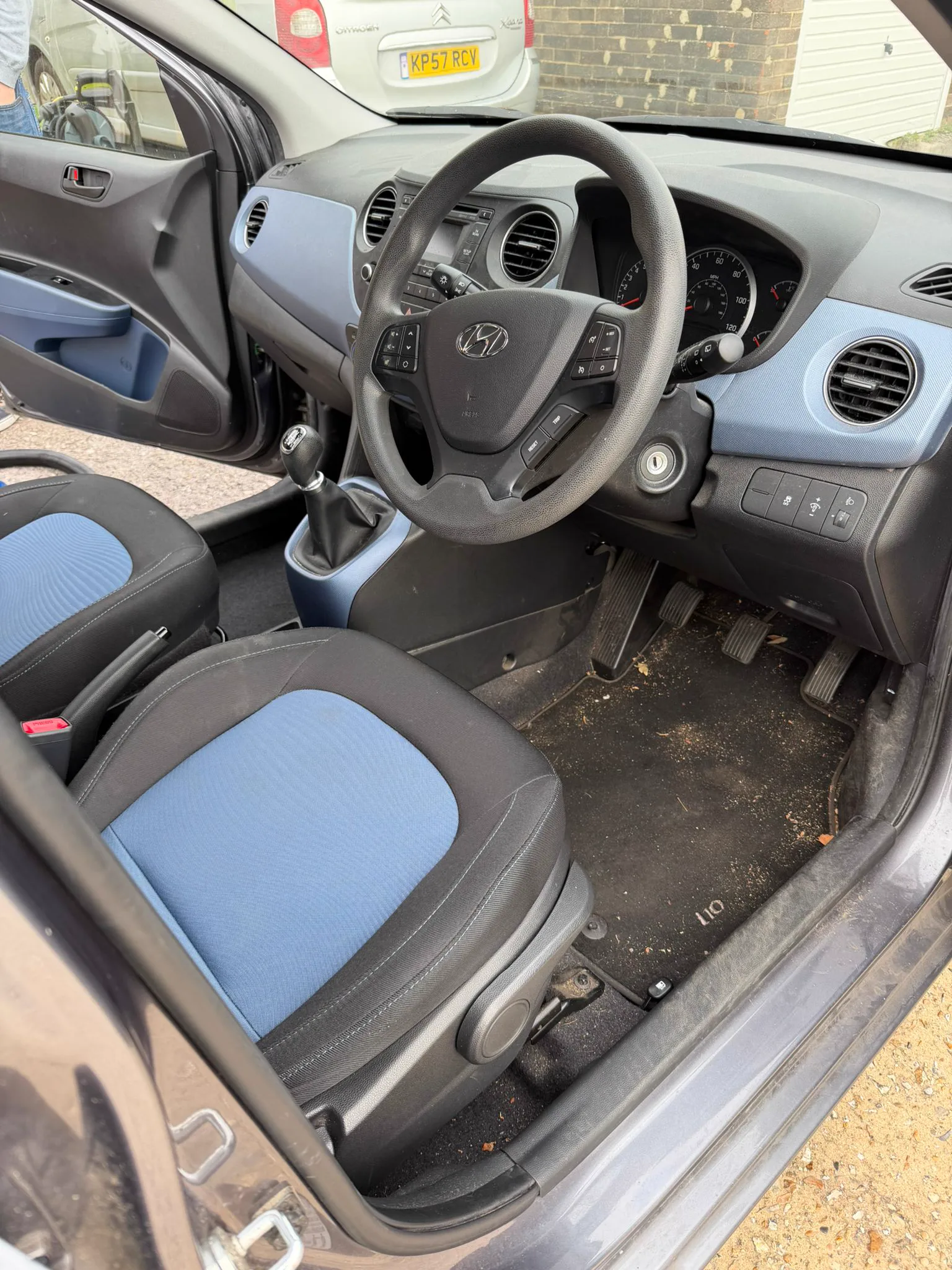 Hyundai i10 driver seat and footwell full of dirt before valeting in Havant